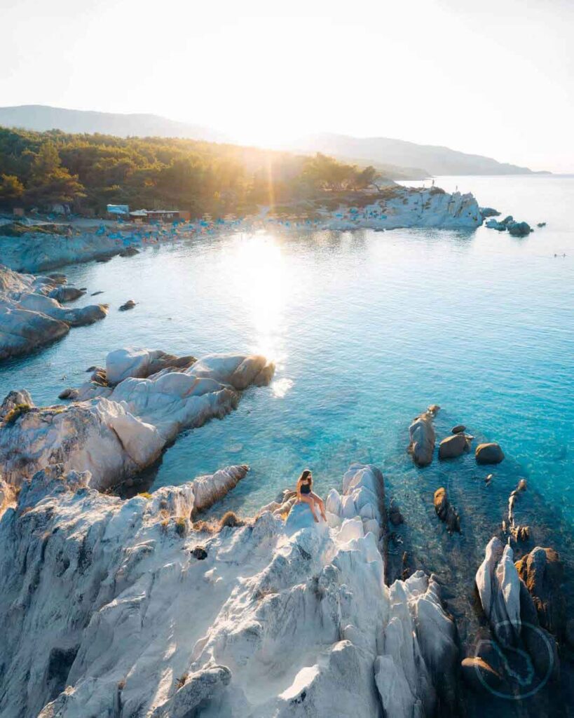 sithonia halkidiki greece, kavourotrypes orange beach, visit sithonia, girl on the rocks on the blue beach in halkidiki, greece